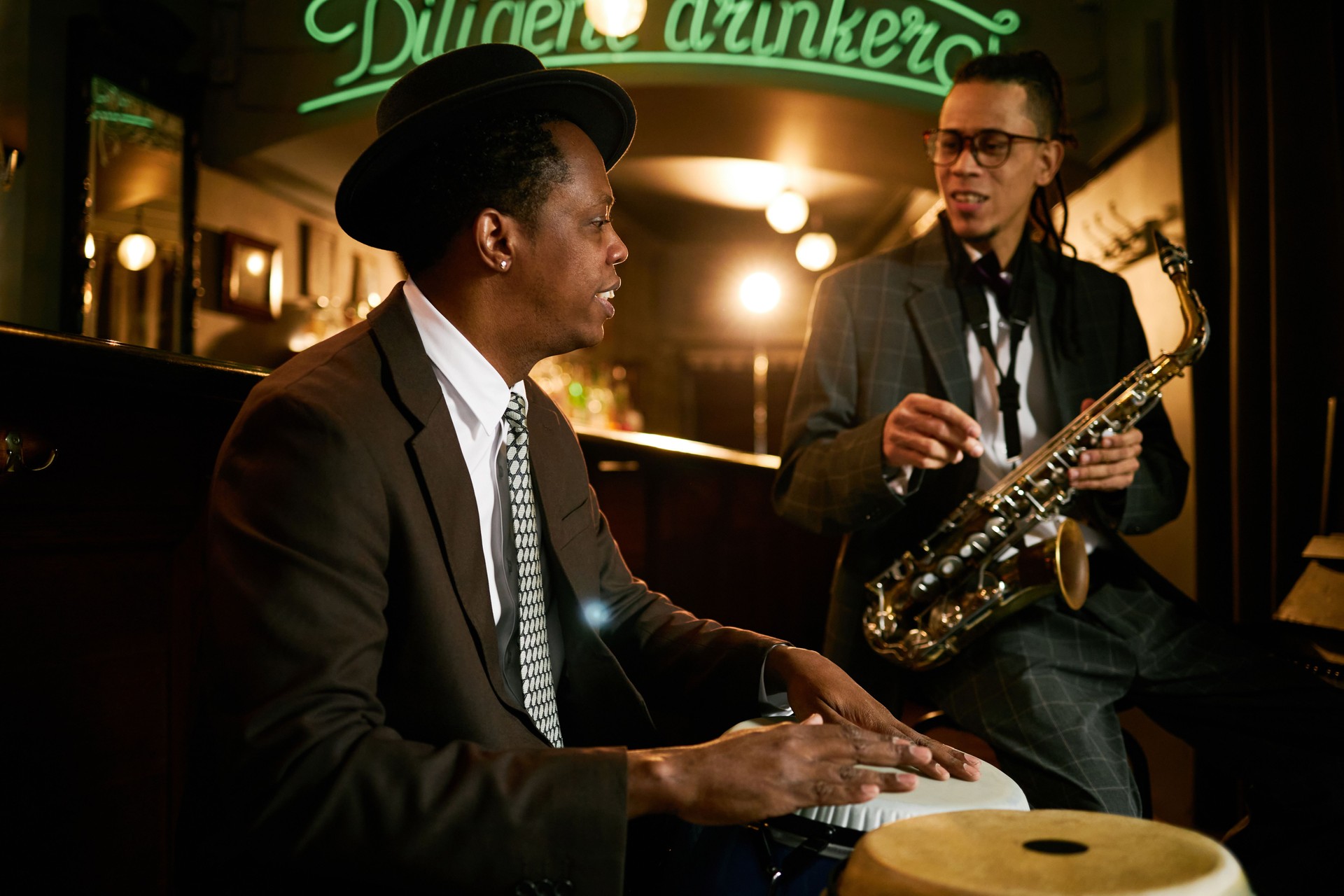 Black Male Drummer Playing Congas Performing Music with Band in Jazz Club